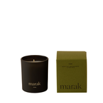 Black candle with 'marak' branding next to its green box on a white background