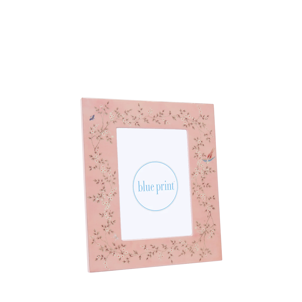 Pink photo frame with floral design on a white background