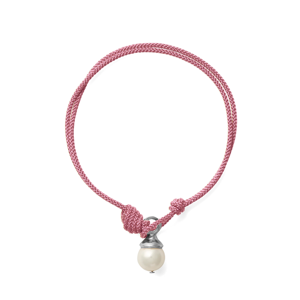 A pink braided cord bracelet with a knot closure and a dangling white pearl bead set in a silver-toned cap, shown on a plain white background.