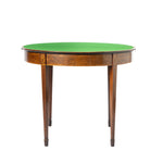 A round mahogany-style game table with a green felt playing surface and a polished brown wood frame with decorative inlays and four tapered legs.