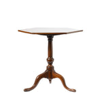 A hexagonal wooden pedestal table with a three-legged turned base, shown against a plain white background.