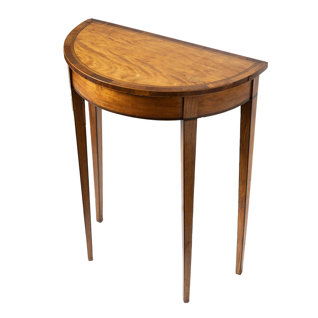 A semi-circular wooden console table with a warm medium-brown finish, featuring four tapered legs and a curved apron, shown on a plain white background.