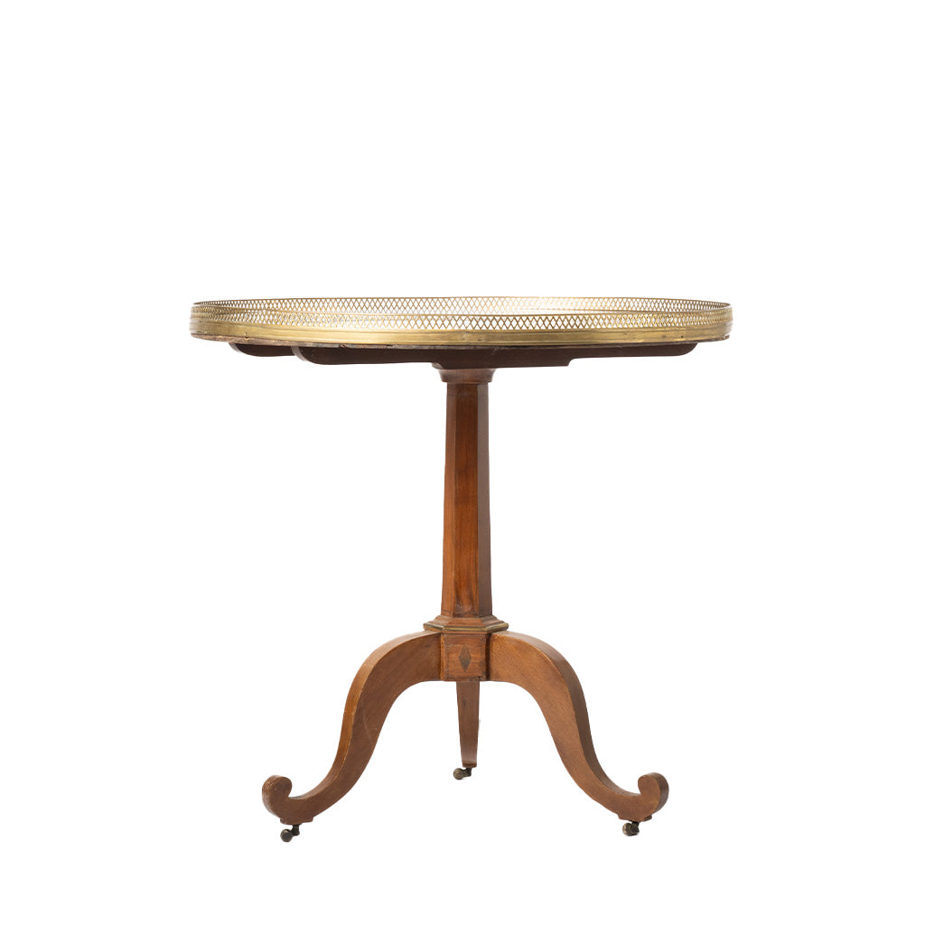 A round wooden pedestal table with a brass mesh top and three curved legs, shown against a plain white background.