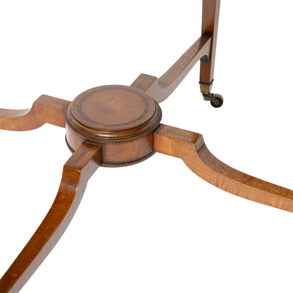 Close-up of a wooden table base with curved legs and small caster wheels, shown on a white background.