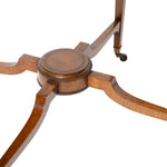 Close-up of a wooden table base with curved legs and small caster wheels, shown on a white background.