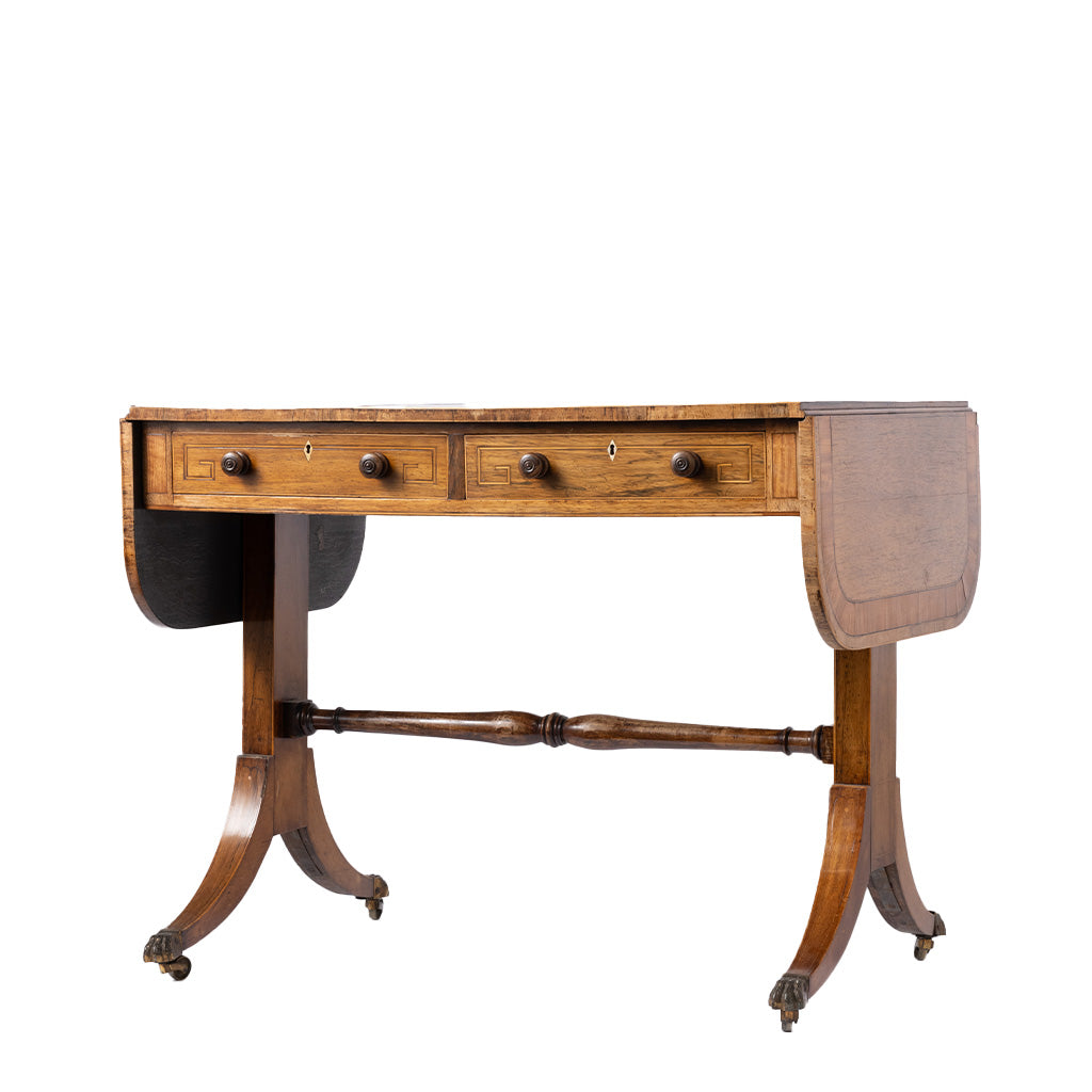 An antique wooden writing desk with drop leaves, three drawers, and a turned central stretcher bar, shown on a plain white background.