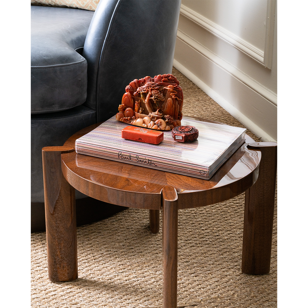 Wooden side table with decorative items next to a sofa