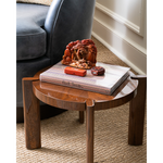 Wooden side table with decorative items next to a sofa