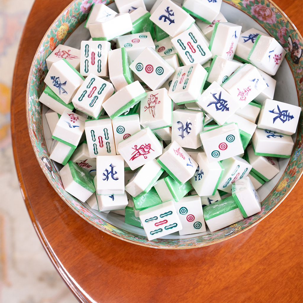 mahjong tile soaps in a bowl on a wooden table