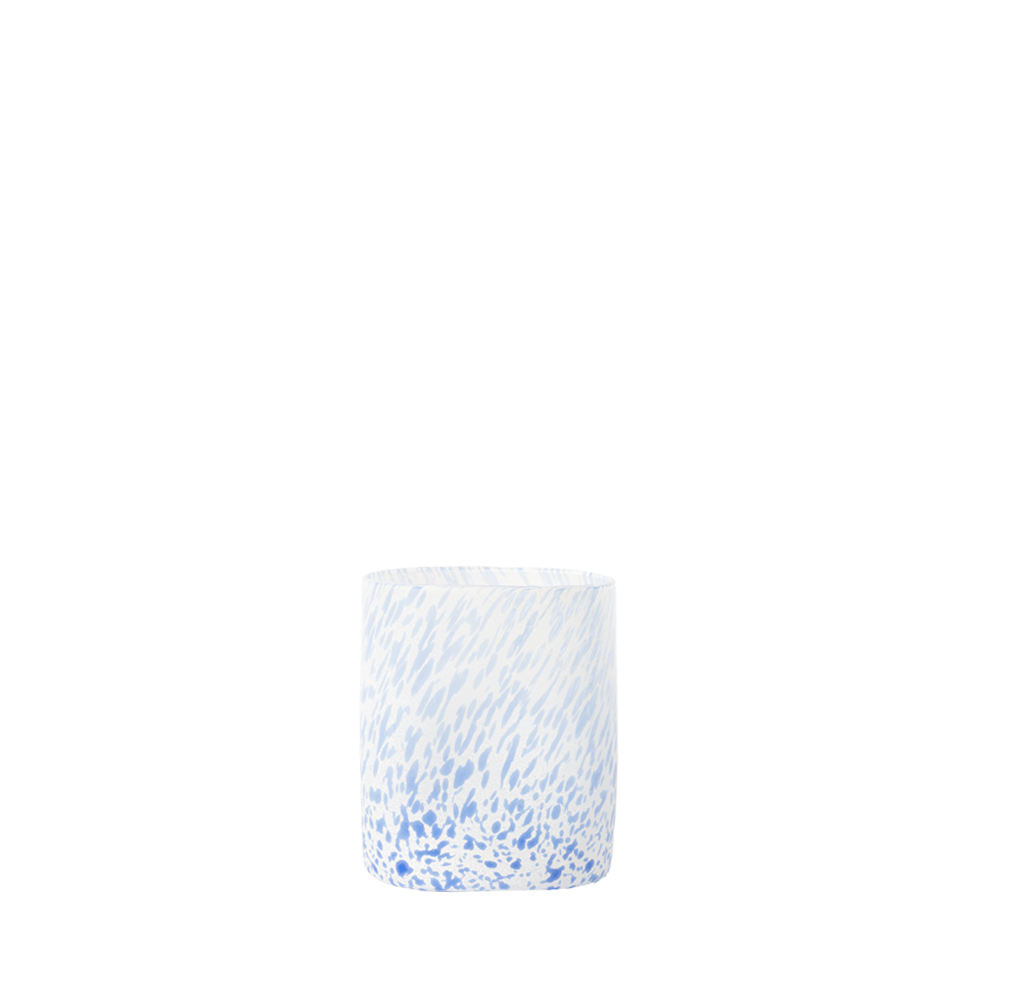 Drinking glass with blue and white pattern on a white background
