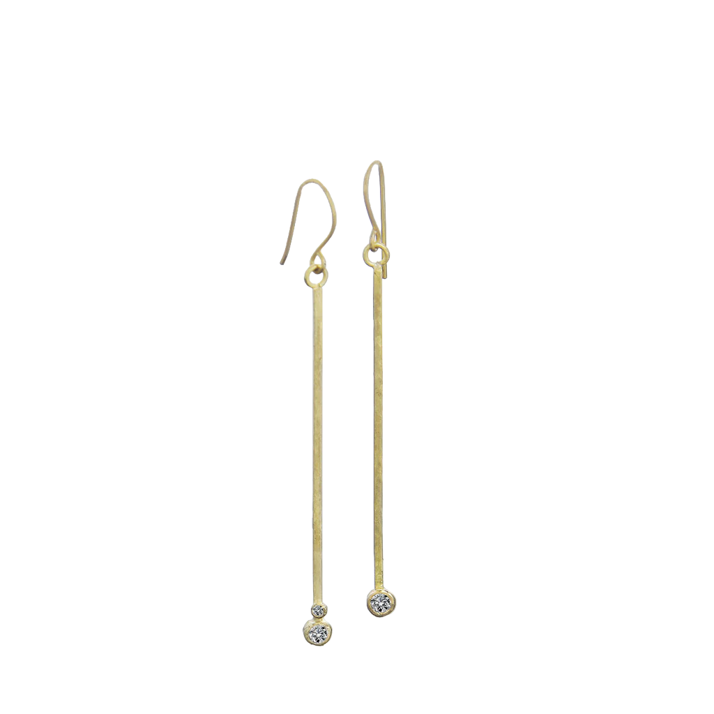 Gold and diamond drop earrings on a white background