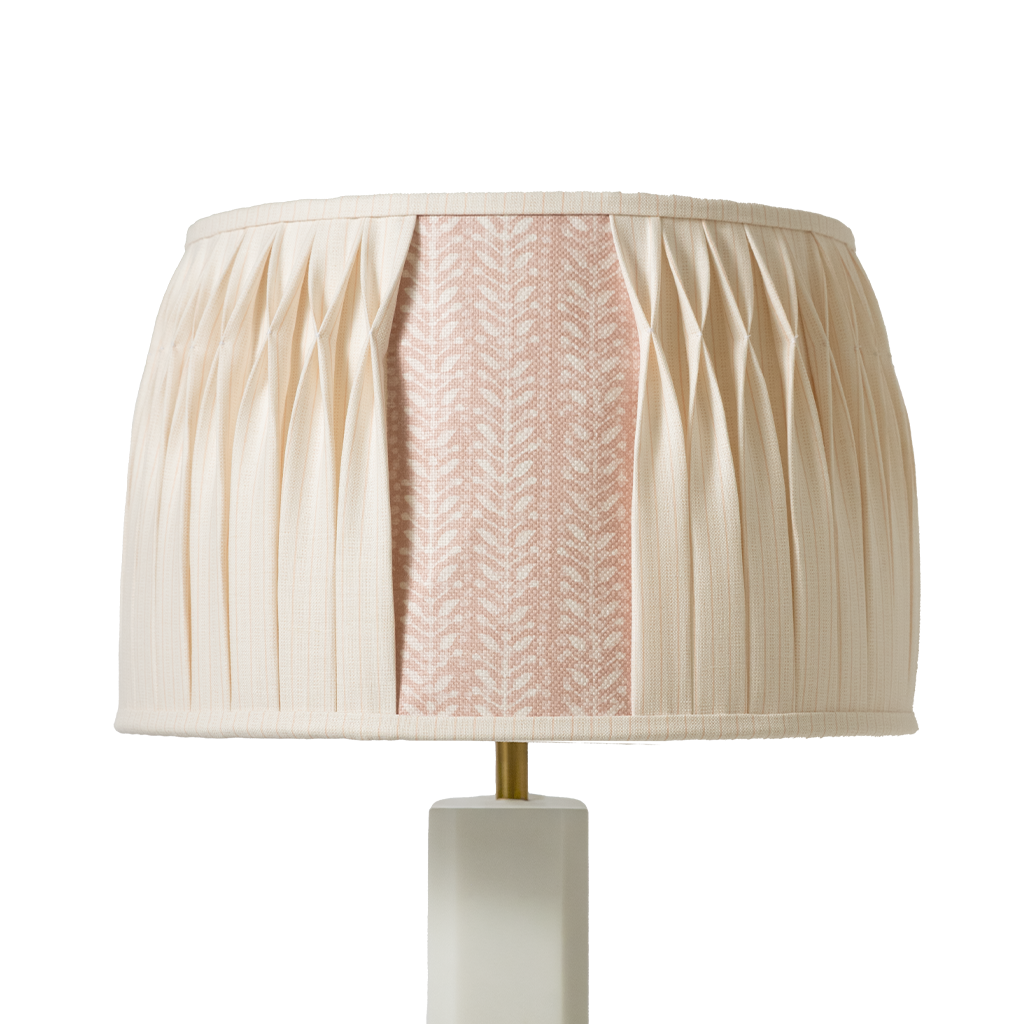 table lamp with a pleated beige shade on a white background