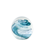 Glass paperweight with blue and white wave design on a white background
