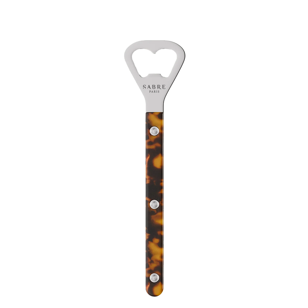 Bottle opener with tortoiseshell handle and silver top on a white background
