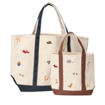 Two canvas tote bags with embroidered Texas-themed motifs, one large and one small, displayed on a clean white background.