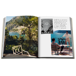 A photo of an open coffee table book with colorful images on a white background