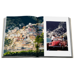 A photo of an open coffee table book with colorful Italian images on a white background