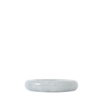 Side view of a round blue resin catch all dish on a white background