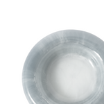 Close up of a round blue resin catch all dish on a white background