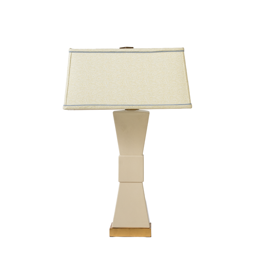 Table lamp with a beige shade and base on a white background