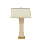 Table lamp with a beige shade and base on a white background