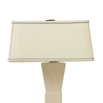 Beige table lamp with a rectangular beige shade on a white background