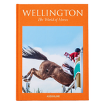 Book titled 'Wellington: The World of Horses' with an orange cover featuring a horse and jockey on a jump.