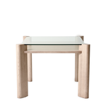 Glass top table with wooden legs on a white background
