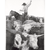 Black and white illustration of a cowboy on horseback surrounded by longhorn cattle.