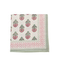 folded napkin. cream napkin with green and pink florals and green and pink trim
