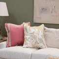 lifestyle image of pheasant down under pillow and pink velvet pillow on sofa