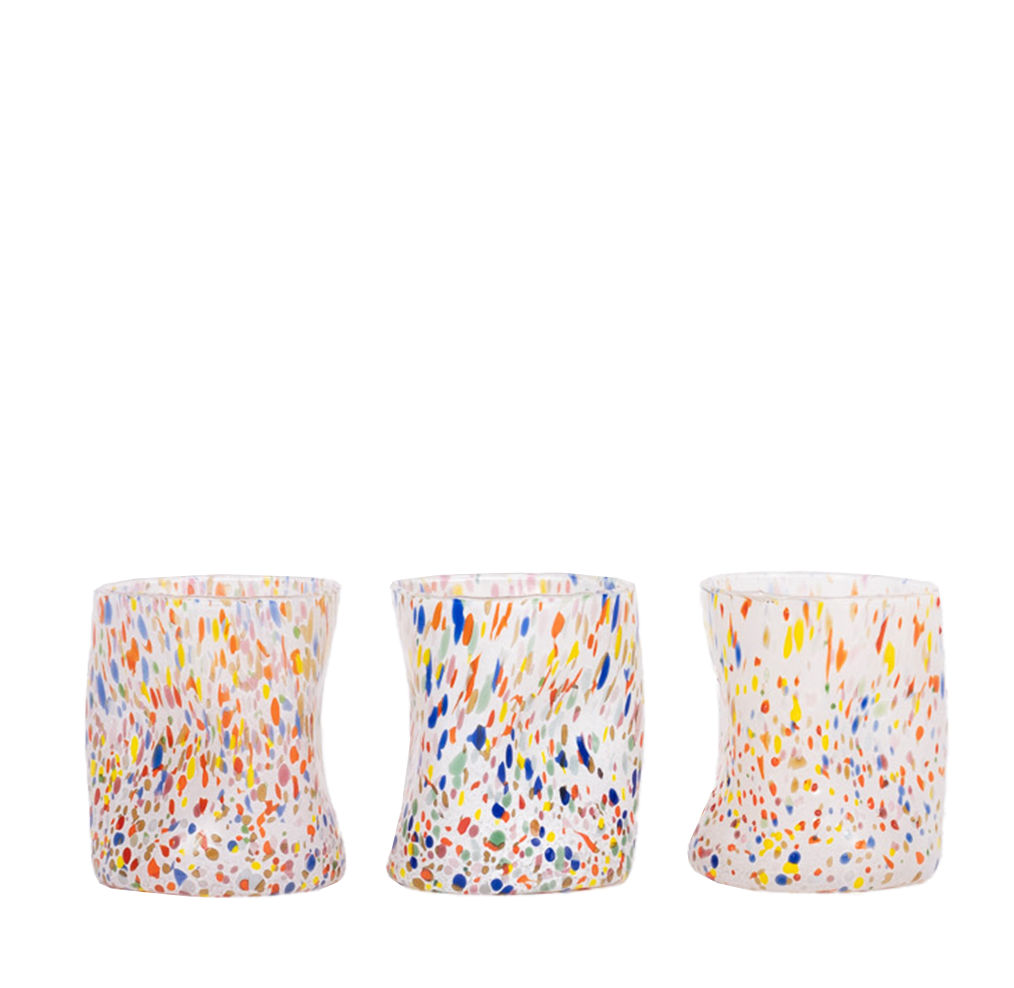 Clear glass tumbler with multi colored speckles and organic shape