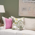 lifestyle image of pink color block pillow and pink and green floral pillow