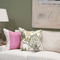 lifestyle image of pink color block pillow and pink and green floral pillow
