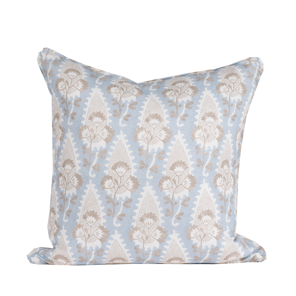 blue pillow with white and tan floral pattern