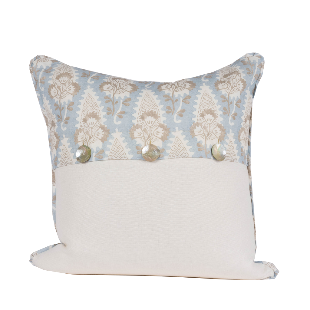 blue pillow with white and tan floral pattern