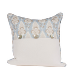 blue pillow with white and tan floral pattern