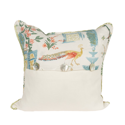pillow with blue, green, red, and gold design featuring peacock in a garden