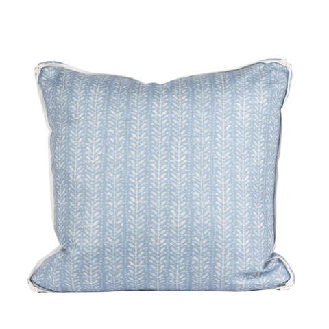 back of blue pillow with white floral fern pattern