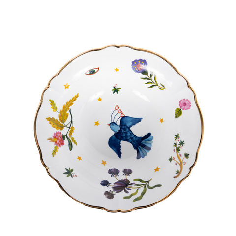 interior of white porcelain salad bowl with bird and floral motifs and a gold rim