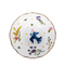 interior of white porcelain salad bowl with bird and floral motifs and a gold rim