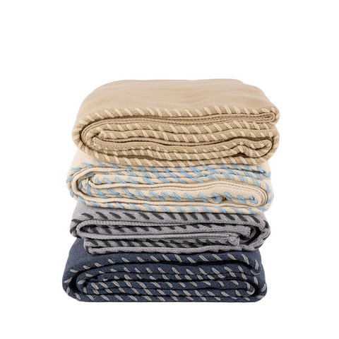 stack of throw blankets in 4 color ways