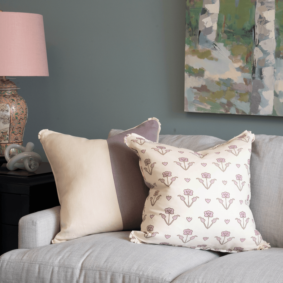 lifestyle image of two purple and ivory pillows