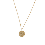 gold necklace with heart in center 