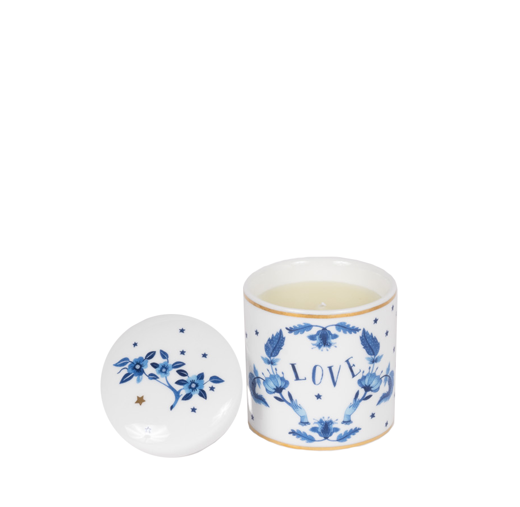 porcelain candle with blue motifs and the word "love", lid off showing blue floral design