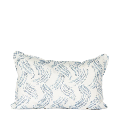 white lumbar pillow with light blue grass pattern