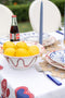 Poros Serving Bowl, Red, on table filled with lemons