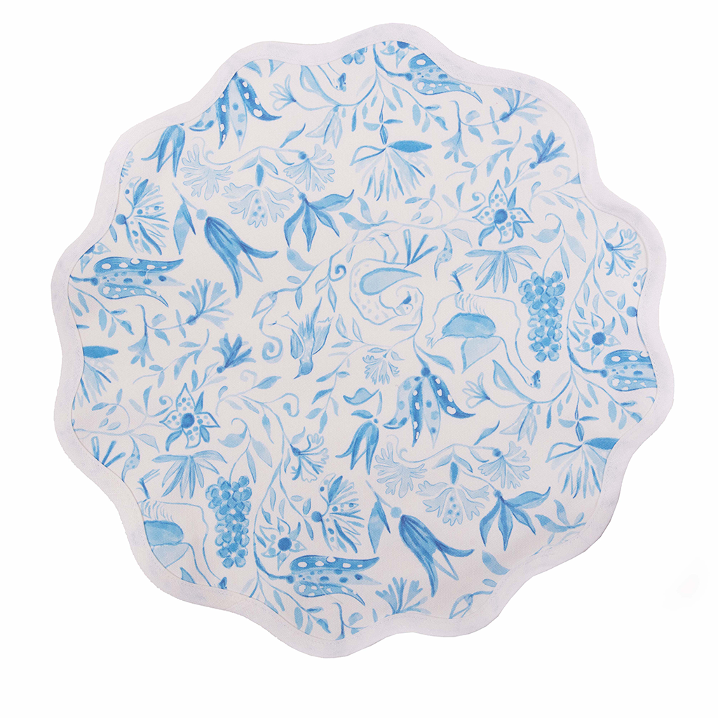 Round white placemat with scalloped edges featuring blue botanical and bird designs.