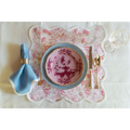 Birds of Paradise Square Scalloped Placemat in pink styled on tablecloth with place setting, flatware and blue napkin