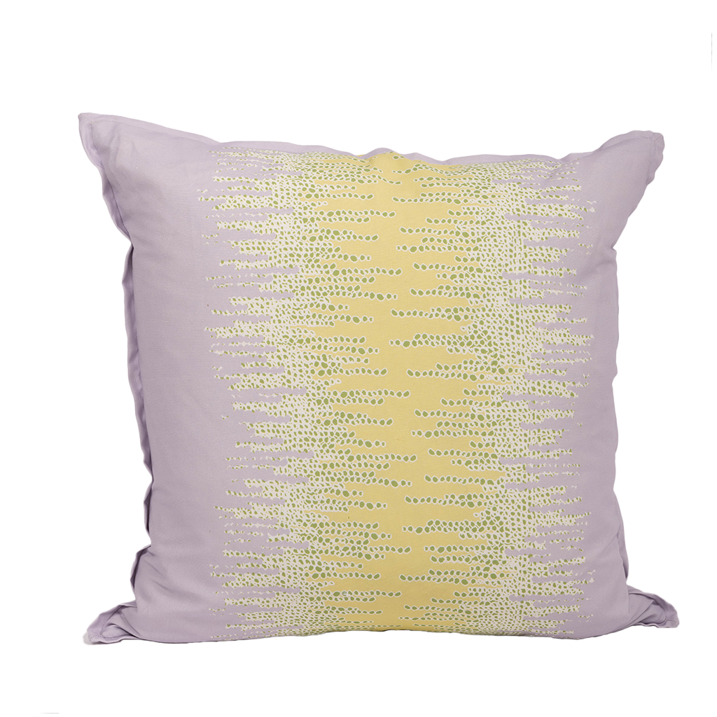purple pillow with yellow center and horizontal dot design